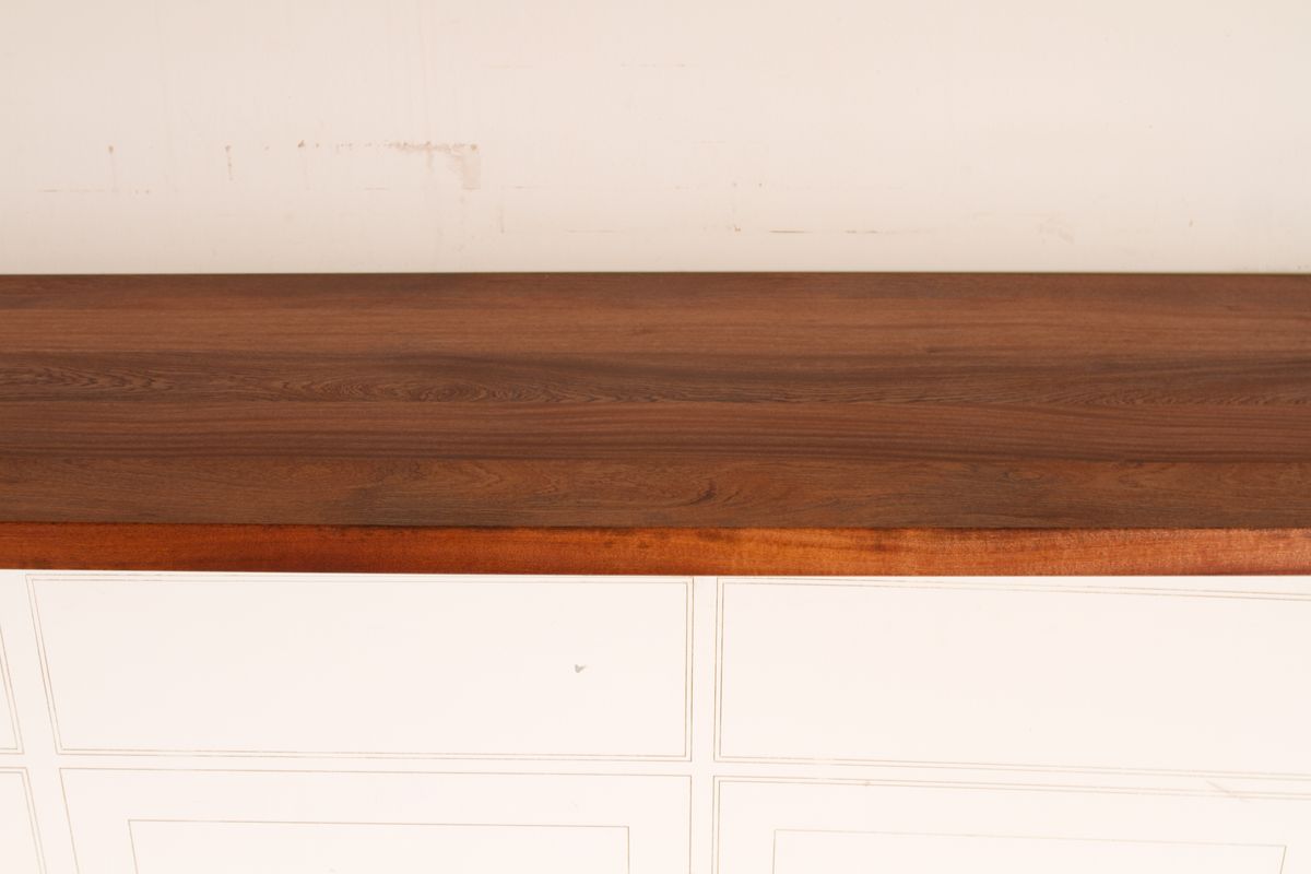 Rich dark sapele worktop on cream painted cabinets