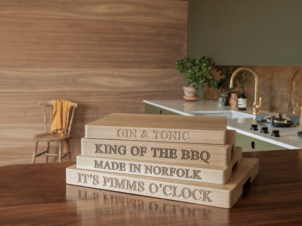 Stack of engraved oak chopping boards including 'King of the BBQ' and 'Made in Norfolk'